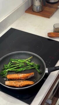Seared Salmon Fillets with Broccolini in Frying Pan Close Up Cooking Process Healthy Food Preparation Gourmet Seafood Meal Pan Fried Salmon Fresh Vegetables Culinary Kitchen 4K Video