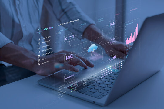 Person interacting with laptop in a dark room with cloud ops control interface