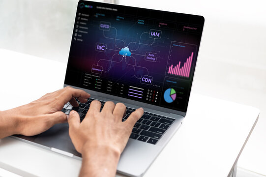 Person working on laptop with cloud operations control panel on screen