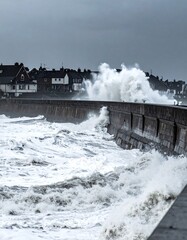 Obraz premium Powerful ocean waves crash against a stone sea wall during a dramatic storm. This moody coastal scene captures raw natural force and resilience, perfect for environmental or news media.