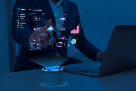 Person analyzing data on futuristic digital dashboard of cloud operations control panel with glowing blue interface in dark workspace