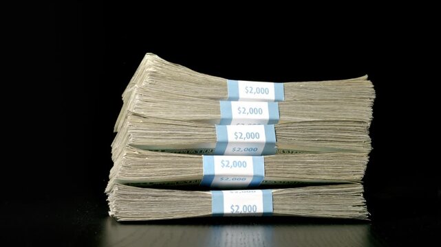 Stack of money falling and landing on a table. Slow Motion.