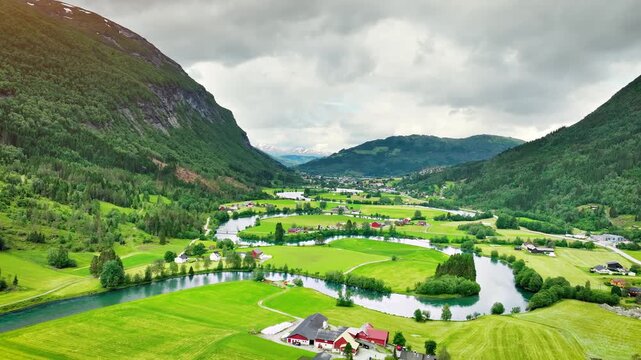 Aerial of a river winding through meadows and farmland near the town of Stryn Norway.