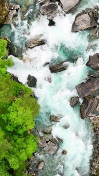 Aerial of a river in Norway. Vertical Video.