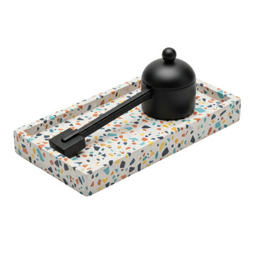 Matte black candle snuffer on a terrazzo tray on a transparent background