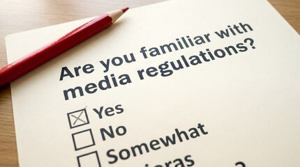 Obraz premium Questionnaire survey sheet about media regulations with red pencil close up