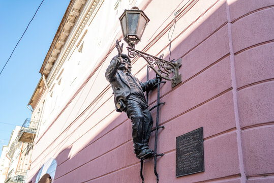 Uzhgorod, Ukraine. April 2026. Bronze lamplighter monument Uncle Kolya on wall in European city