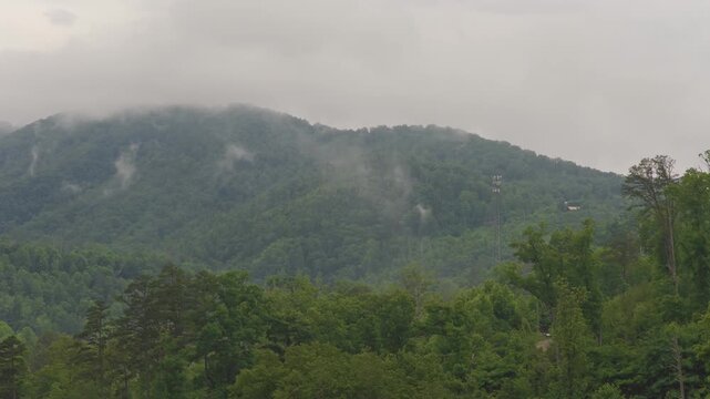 Aerial drone landscape of Smoky Mountains Appalachia Tennessee hiking, camping, and wildlife vacation preserve by Gatlinburg and Pigeon Forge, TN with mist, fog, moirning light, trees, and forest 4k