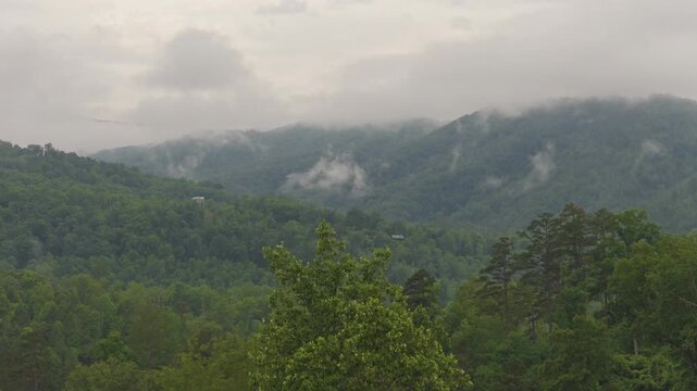 Aerial drone landscape of Smoky Mountains Appalachia Tennessee hiking, camping, and wildlife vacation preserve by Gatlinburg and Pigeon Forge, TN with mist, fog, moirning light, trees, and forest 4k