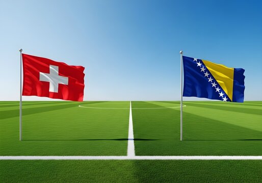 Two national flags waving on a football field under a clear blue sky