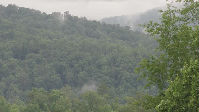 Aerial drone landscape of Smoky Mountains Appalachia Tennessee hiking, camping, and wildlife vacation preserve by Gatlinburg and Pigeon Forge, TN with mist, fog, moirning light, trees, and forest 4k