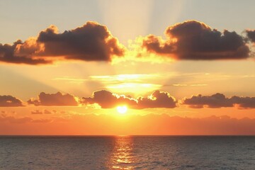Fototapeta premium Ocean horizon at sunset or sunrise with warm clouds and bright sun rays reflecting on the water surface. Evening sea landscape with fiery sky.