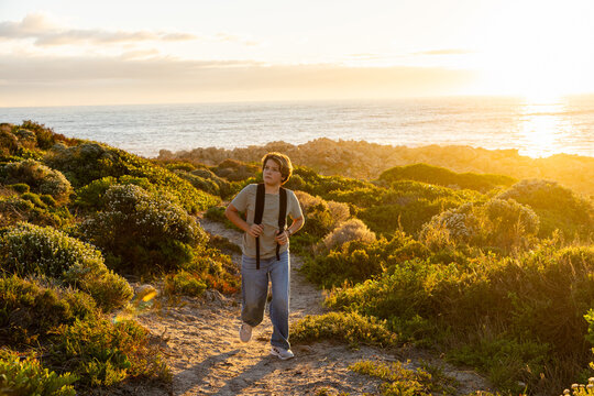 child, boy young boy, active, exercise, exploring, sunset, coastline, dekelders, South Africa, western cape, nature, walking, people, path, landscape, waves, water, ocean, sea,  travel, summer, person