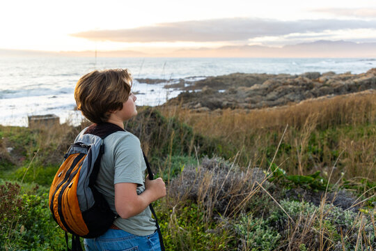 12 year old hiker on nature trail at sunset near DeKelders, South Africa