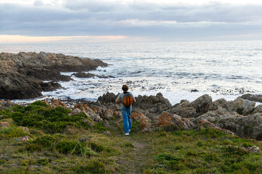 12 year old hiker on nature trail at sunset near DeKelders, South Africa