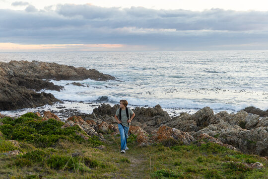 12 year old hiker on nature trail at sunset near DeKelders, South Africa