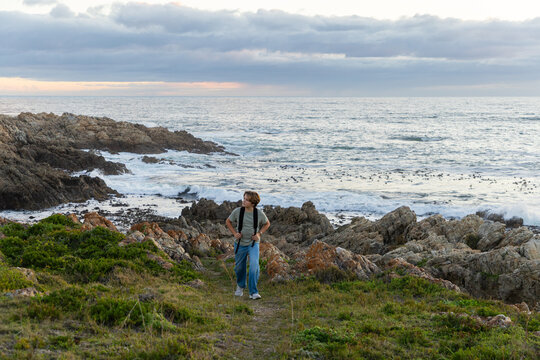12 year old hiker on nature trail at sunset near DeKelders, South Africa