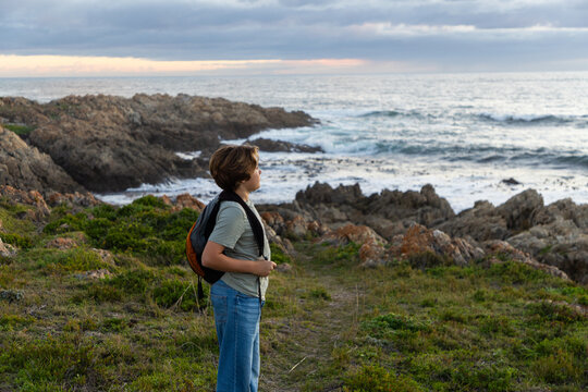 12 year old hiker on nature trail at sunset near DeKelders, South Africa