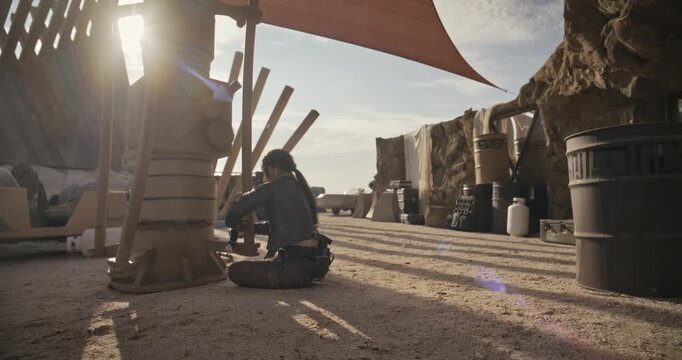 Female adventurer escaping handcuffs and sneaking off into sci-fi desert - wide shot