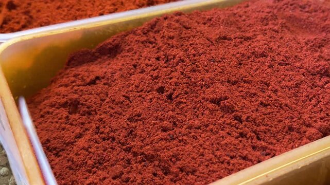 Aromatic smoked paprika mixed with crushed chili flakes in spice container with deep red color and flavorful seasoning concept for culinary use.