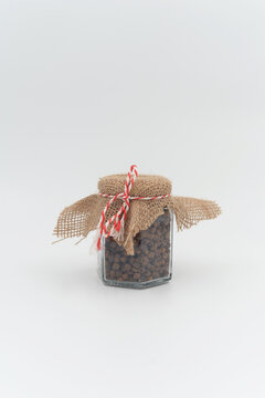 Small decorated jar with perga ( bee bread) product on white background