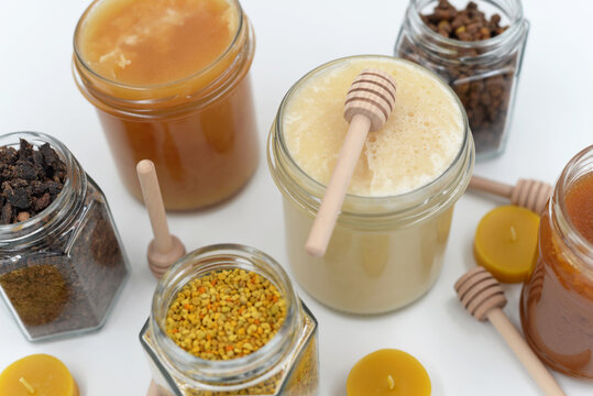 Flat lay composition of honey and bee products on white