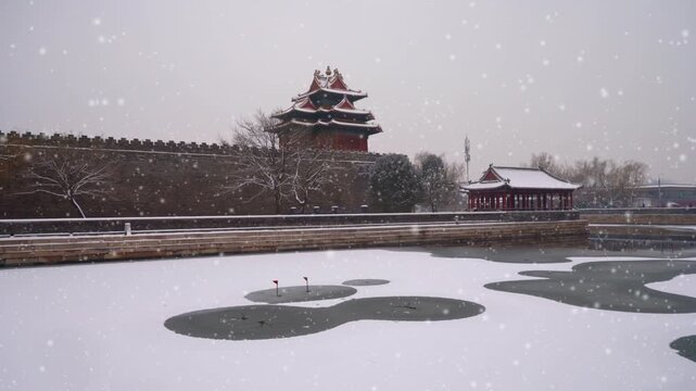 Snowfall over Forbidden City corner tower and frozen moat in Beijing in Forbidden City, Beijing, China