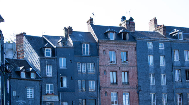 Blue-painted half-timbered Norman house with brick and timber facade