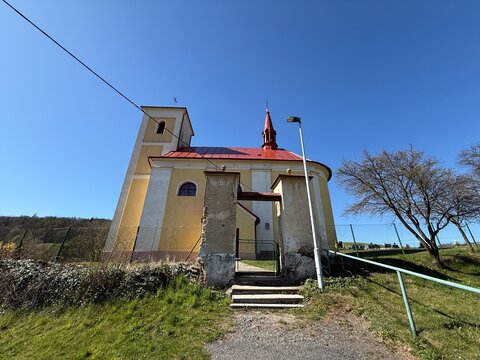 Yellow baroque church with red roof and tower in Lukavec near Fulnek (CZ)