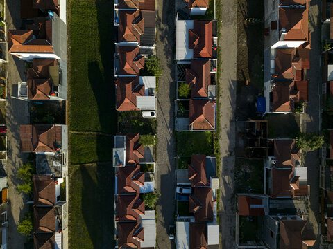 Aerial view of Sadari Villa Prambanan residential complex featuring rows of houses with orange tiled roofs and narrow streets in Kecamatan Prambanan, Jawa Tengah, Indonesia.