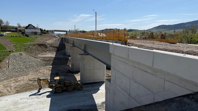 Construction of railway line LK104 with advanced ground stabilization and engineering structures. Geotechnical works including pile walls, soil reinforcement, ground nails, and slope protection system