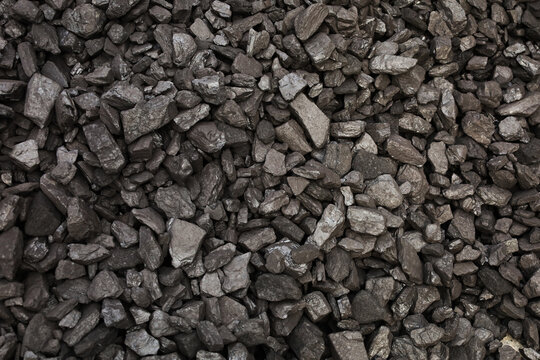 Dark coal piles form a rough mound