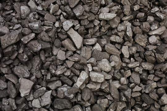 Dark coal piles form a rough mound