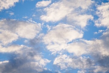 Obraz premium Clouds illuminated by the evening sun with dark areas as a background. 