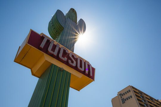 Sun shining behind a &ldquo;Welcome Tucson&rdquo; sign shaped like a saguaro cactus in Tucson, Arizona, September 2020
