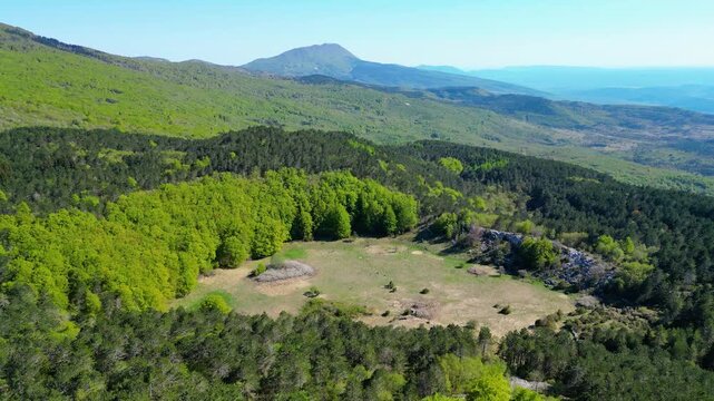 Aerial view of Ucka Nature Park in spring, showcasing lush forests and rolling hills under a clear blue sky. A pristine natural escape in Croatia.