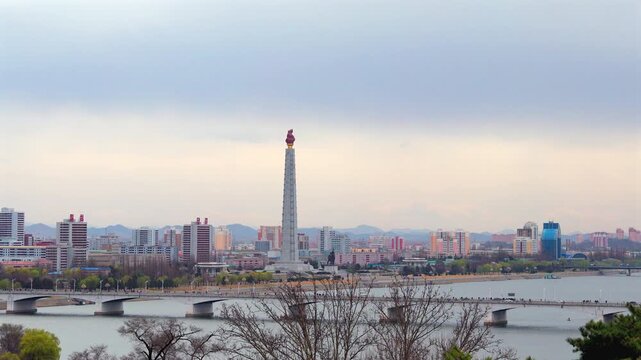 Juche Tower, Pyongyang morning panoramic view, North Korea. Taedong River in the morning fog. View facing upstream, modern residential complex. View from Yanggakdo Hotel