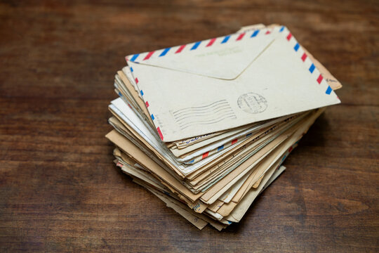A stack of letters on the table.Write paper letters and send them by mail.