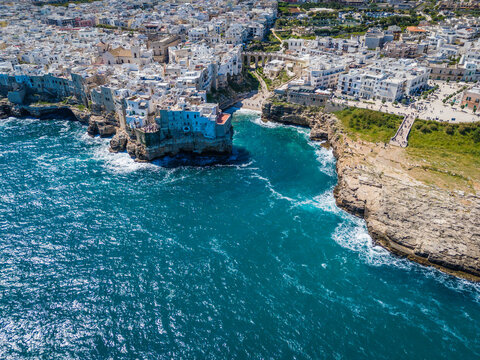 Aerial drone panorama view of Polignano a Mare with Lama Monachile beach, stunning Adriatic sea coastal townscape in Puglia, southern Italy