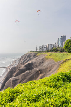 Paragliding above cliffs in Miraflores neighborhood of Lima, Peru
