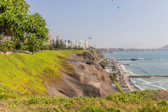 Paragliding above cliffs in Miraflores neighborhood of Lima, Peru