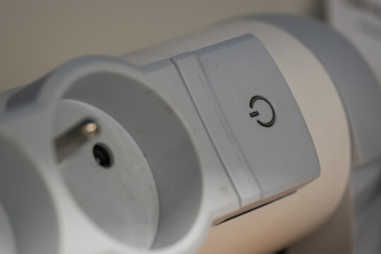 Close-up of a power button on a power strip or electrical socket.