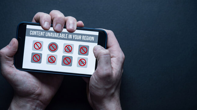Man holding smartphone displaying content unavailable in your region message. Internet blocking and social media access restriction concept. Digital censorship and geo location filter issue.