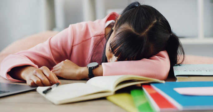 Books, education and sleeping with girl on desk in home for burnout, cram session or fatigue. Learning, study and tired with exhausted student in apartment for development or exam preparation