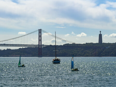 Sailboats on the Tagus River with Ponte 25 de Abril bridge in Lisbon