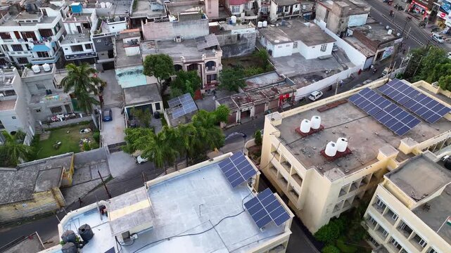 Aerial view of rooftop solar panels on residential homes in India.