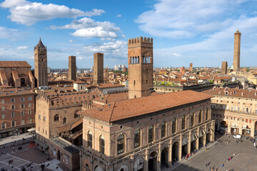 Fototapeta premium Aerial view of Piazza Maggiore in Bologna old town, Emilia Romagna, Italy, with historic architecture, Palazzo del Podesta and towers at sunrise. Italian cityscape. Travel destination in Europe