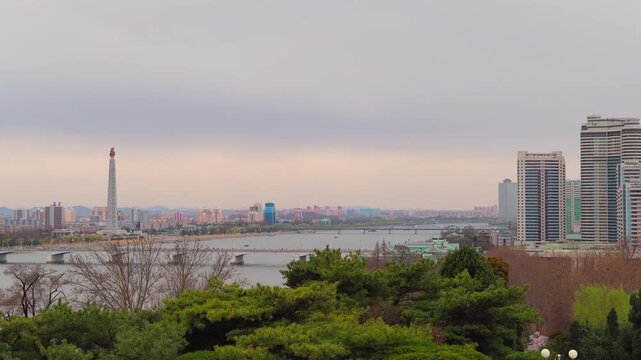 Juche Tower, Pyongyang morning panoramic view, North Korea. Taedong River in the morning fog. View facing upstream, modern residential complex. View from Yanggakdo Hotel