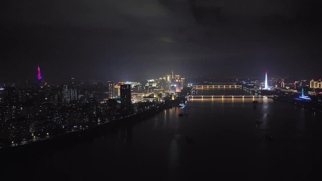Juche Tower, Pyongyang morning panoramic view, North Korea. Taedong River in the morning fog. View facing upstream, modern residential complex. View from Yanggakdo Hotel