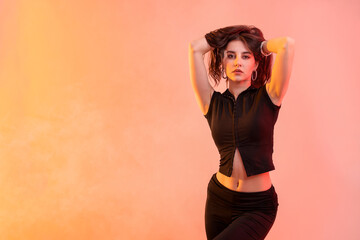 Young hip-hop dancer posing in smoke on color background, space for text